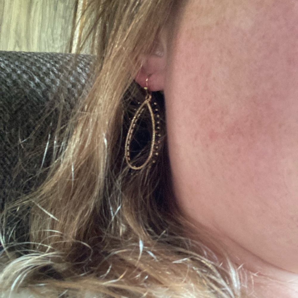 Gold and black earrings for pierced ears.